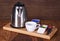 Group of coffee making set in a hotel room with stainless steel electric kettle, clean cup, teaspoon.