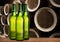 Group of cold wet beer bottles in the cellar with vintage kegs