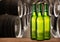 Group of cold wet beer bottles in the cellar with vintage kegs