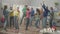 A group of colleagues in festive hats and glasses are dancing, having fun, celebrating a common success, a birthday