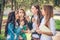 Group of College Girls Blowing Dandelion Seeds