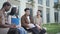 a group of college students talk on the campus of the university during a break