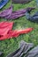 A group of colorful clothes are layed on the green grass.