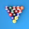 A group of colorful glossy billiard balls with numbers on a blue billiard table