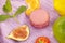Group of colorful macaroons and fruits on purple towel
