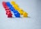 Group of colorful meeples of teams isolated on gray background. Small figures of man. Board games concept