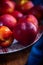 A group of colorful nectarine fruits or peach on a plate