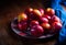 A group of colorful nectarine fruits or peach on a plate