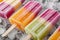 Group of colorful popsicles on ice, close up