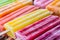 Group of colorful popsicles on ice, close up