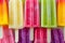 Group of colorful popsicles on ice, close up