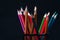 Group of colorful sharpened pencils on black