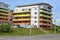 Group of coloured apartment dwelling houses next to the public route