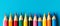 Group of colourful pencils over blue background.