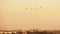 Group of combat helicopters over the city MI-8 red warm sunset