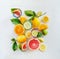 Group composition of various organic citrus fruits with green leaves on white background, top view. Healthy food.  Ingredients.