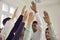 Group of confident diverse people raising hands up in the air, voting or showing solidarity