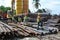 Group of construction workers lifting bundle of reinforcement bar using crane