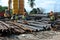 Group of construction workers lifting bundle of reinforcement bar using mobile crane