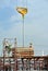 Group of construction workers lifting bundle of timber using mobile crane