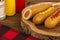 Group of corn dogs on a wooden table. Fast food concept. Close up