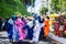 Group of costumed people run during the Fuzue parade