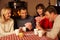 Group Of Couples Playing Cards Together