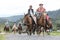 Group of cowboys on horseback