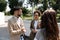 Group of coworkers walking outside in front of office buildings discuss about business plan. Businesspeople marketing sale experts