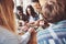 Group of creative multietnic friends sitting at wooden table. People having fun while playing board game