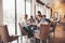 Group of creative multietnic friends sitting at wooden table. People having fun while playing board game