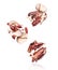 Group of crushed pecan nuts in the air close-up on a white background