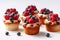 A group of cupcakes topped with berries and blueberries. AI generative image.
