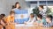 Group of curious preteen learners and young female teacher with flag of Argentina in classroom of academy