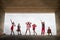 Group of cute children in stylish clothes having fun together and clouds sky background. Yound models posing during photoshoot