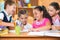 Group of cute schoolchildren having fun in classroom