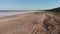 Group of cyclists ride on bike along coastline of Kuyalnik estuary. Drone flies over riders on bicycles with view on Kuyalnik Lima