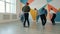 Group of dancers man and women dancing in modern dancehall indoors