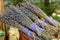 Group of delicate dried lavender bouquets with lila textile material, displayed for sale at an weekend deco fair for handmade arti