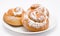 Group of delicious cinnamon rolls icing sugar on plate isolated
