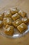 Group of delicious sweet Christmas honey gingerbread cookies on wooden table on trasparent glass plate, various shapes