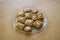 Group of delicious sweet Christmas honey gingerbread cookies on wooden table on trasparent glass plate, various shapes