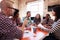 Group Of Designers Having Meeting Around Table In Office