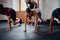 Group of determined multiracial young adults with trainer doing mountain climbers at the gym