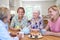 Group Of Different Aged Female Friends Meeting At Home