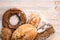 Group of different breads on a light wooden background