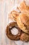 Group of different breads on a light wooden background. Vertical banner concept