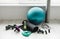 Group of different exercising equipment on white home gym floor.