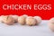 Group of dirty chicken eggs on gray background, with shadows and text chicken eggs on red background. Healthy food