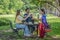 Group of diverse asian university LGBTQ student classmate as teamwork doing group homework together in campus park